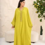 A luxurious Moroccan kaftan with traditional embroidery and an elegant gold belt