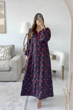 An elegant silk kaftan with a cherry pattern and distinctive red accents